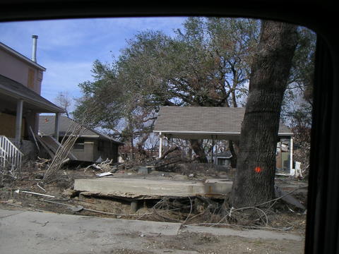 House lifted off its foundation and destroyed during flooding after flood wall breached.